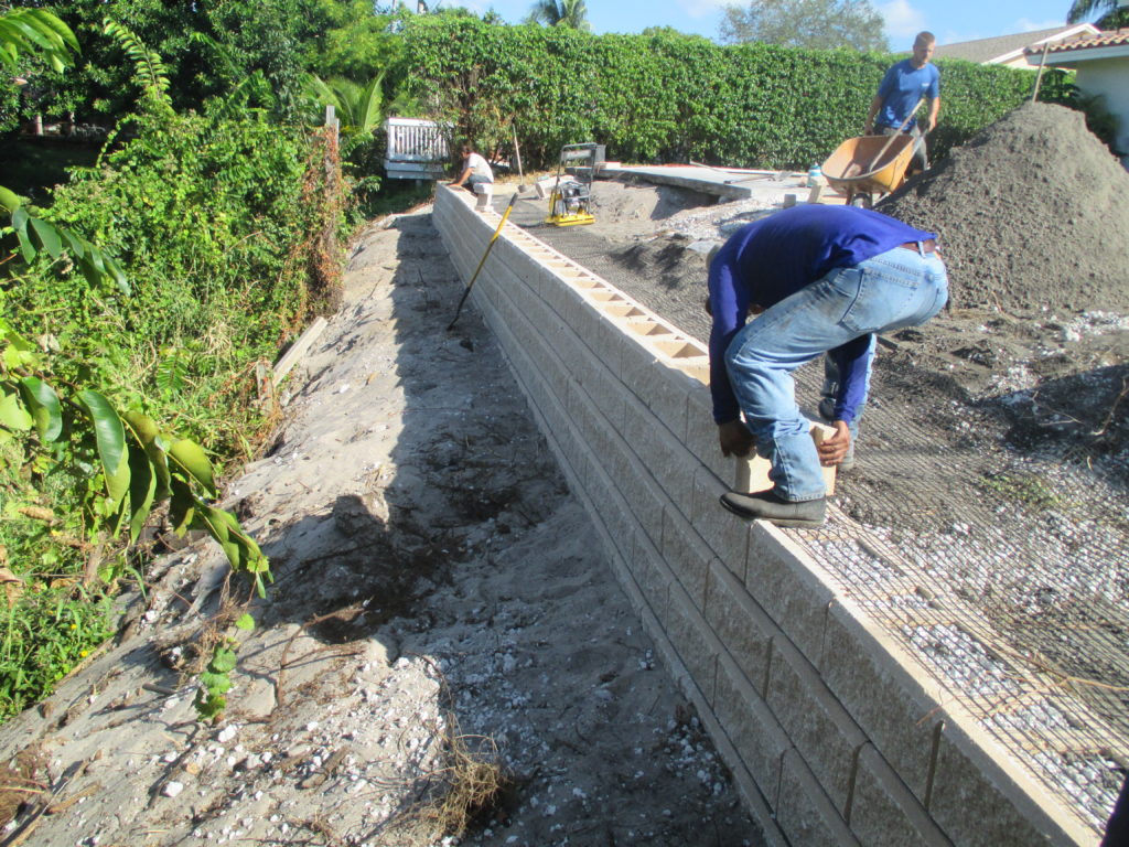 Retaining block wall holding property in backyard slope - Universal ...